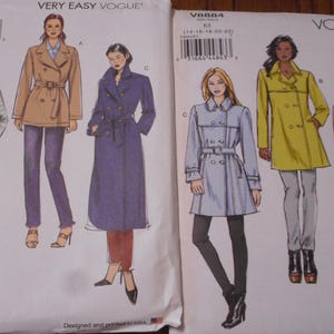 May include: Two Vogue sewing pattern envelopes. One features a tan trench coat, a purple coat, and a plaid coat. The other shows a light blue coat, a yellow coat, and a pink coat. The patterns are for coats.