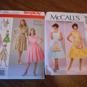 May include: Two sewing patterns for dresses. The Simplicity pattern is for a 1950s vintage style dress and has a number of different styles. The McCall's pattern is for a dress with a gingham pattern and a floral pattern. The McCall's pattern number is M7599.