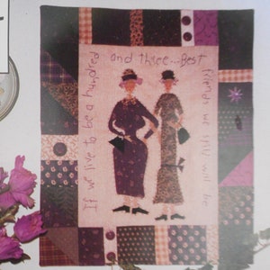 May include: A purple and brown patchwork quilt with two women in dresses and the text "If we live to be a hundred and three... Best friends we still will be".