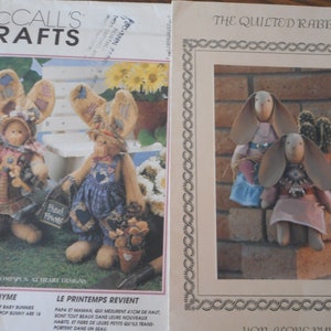 May include: Two sets of sewing patterns for making quilted bunny dolls. The first pattern is for a larger bunny doll with a bucket of baby bunnies. The second pattern is for two smaller bunny dolls. Both patterns are from McCall's Crafts.