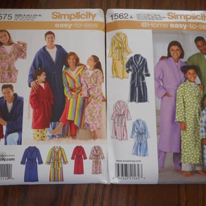 May include: Two Simplicity sewing pattern envelopes. One features a family in bathrobes, the other shows illustrations of robes. The patterns are for easy-to-sew robes in various colors and patterns.
