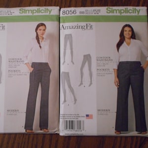 May include: Two Simplicity sewing pattern envelopes for pants, one in size AA and one in size BB. Both patterns feature the text "Amazing Fit" and "Contour Waistband".