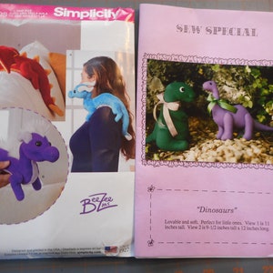 May include: Sewing pattern for making plush dinosaur toys. The pattern includes instructions for making a green dinosaur, a purple dinosaur, a purple dragon, and a blue dragon. The pattern is from Simplicity and is part of their Sew Special series.