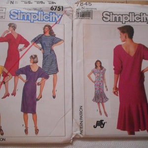 May include: Two Simplicity sewing patterns for dresses. The pattern on the left is number 6751 and features four different dress styles. The pattern on the right is number 7845 and features a single dress style.