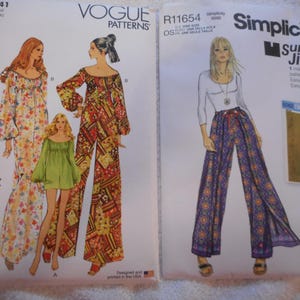 May include: Two vintage sewing patterns for women's clothing. The pattern on the left is Vogue V2041 and features a long, floral print dress and a shorter, green dress with bell sleeves. The pattern on the right is Simplicity R11654 and features a pair of wide-legged pants with a floral print.