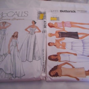 May include: Two vintage sewing pattern envelopes. One is McCall's "Evening Elegance" with illustrations of wedding gowns. The other is Butterick with illustrations of evening wear. Both are white and cream colored.