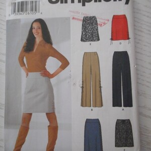 May include: Simplicity sewing pattern number 5801 for sizes 12, 14, 16, and 18. The pattern includes instructions for making six different skirts: a white skirt with side slits, a red skirt with side slits, a leopard print skirt, a brown skirt with side slits, a blue skirt with side slits, and a black and white patterned skirt.