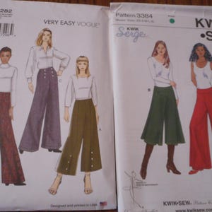 May include: Two sewing pattern covers. The left cover is labeled "VERY EASY VOGUE" with a drawing of three women wearing wide-leg pants. The right cover is labeled "KWIK SEW" with drawings of women in wide-leg pants. The patterns are for women's clothing.
