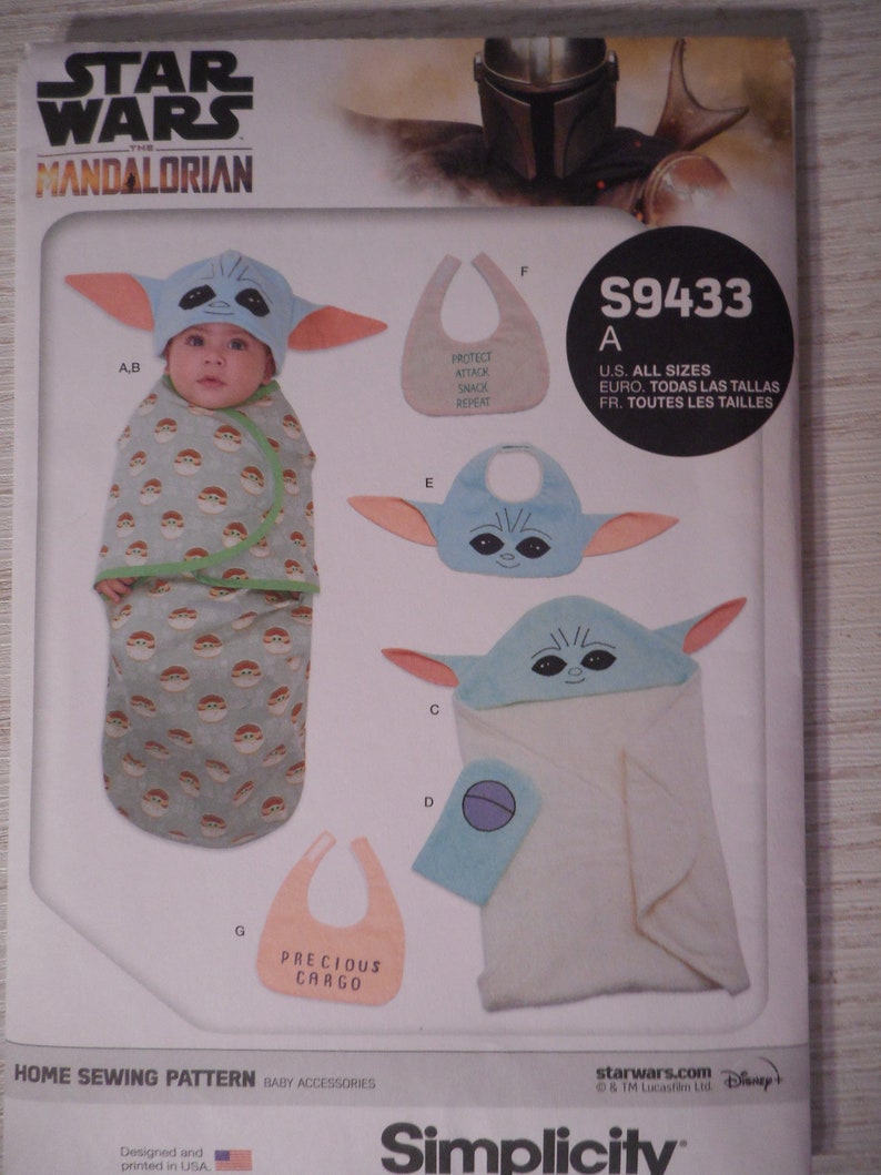 May include: A sewing pattern for a baby costume inspired by the Star Wars character, The Child, also known as Baby Yoda. The pattern includes instructions for making a hooded towel, a bib, and a hat with ears. The pattern is for all sizes and is available in English, French, and Spanish. The pattern is from Simplicity.