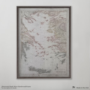 May include: A vintage map of the Aegean Sea with coasts and islands in red and brown, framed in a distressed dark silver hardwood frame.