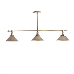 May include: A three-light pendant fixture with a brass finish. The fixture has three conical shades and a horizontal bar with decorative ball finials. The fixture is suspended from a central rod.