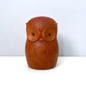 May include: A set of three ceramic mugs with a speckled, matte finish. The mugs are in shades of cream, light gray, and dark gray. Each mug has a simple, minimalist design and a rounded handle.