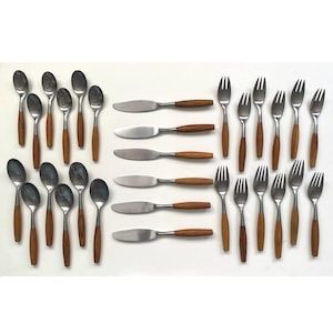 May include: A set of vintage cutlery, including spoons, knives, and forks. The utensils feature stainless steel heads and wooden handles. The spoons are oval, the knives have a rounded blade, and the forks have four prongs. The cutlery is arranged on a white surface.