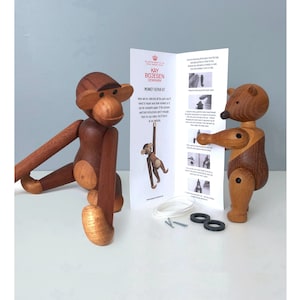 May include: Wooden monkey and bear figurines with articulated limbs. The monkey is brown with a light wood belly and face. The bear is brown and light wood. A repair kit with instructions and replacement parts is included.