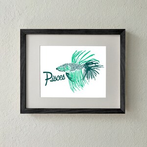 May include: A framed print of a green and black stylized illustration of a fish with the word "Pisces" written below it.
