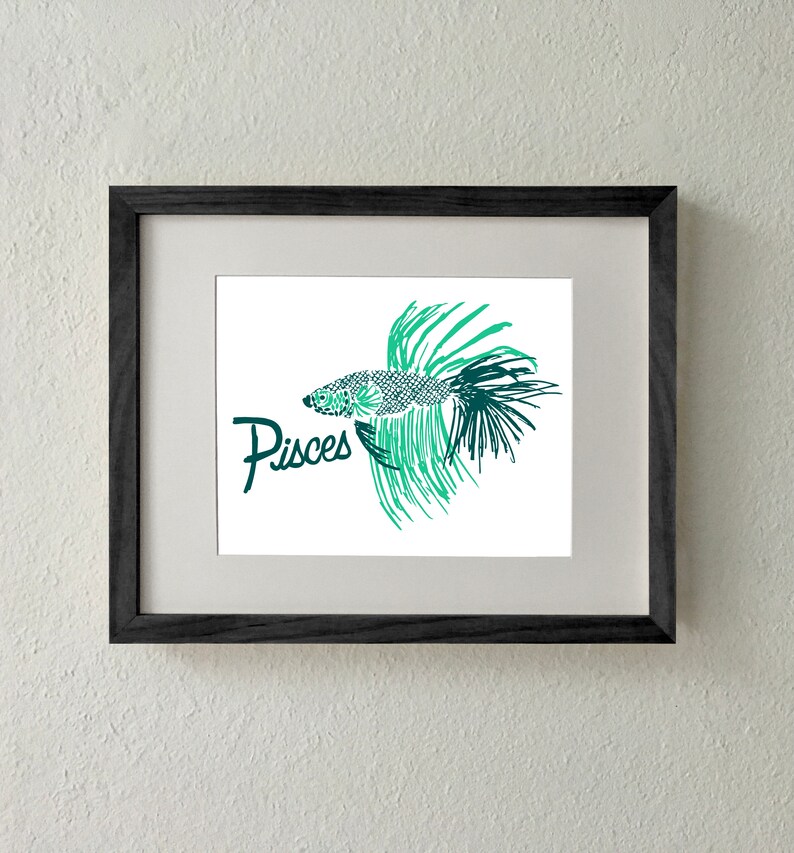 May include: A framed print of a green and black stylized illustration of a fish with the word "Pisces" written below it.
