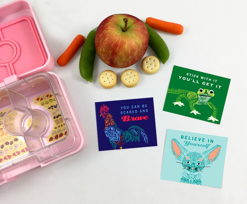 May include: Three colorful cards with inspirational messages and illustrations of a rooster, a frog, and a fennec fox. The text on the cards reads "You can be scared and brave", "Stick with it you'll get it", and "Believe in yourself".