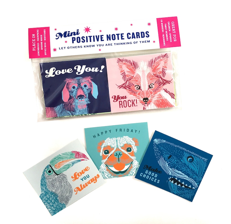 May include: A set of mini positive note cards featuring colorful illustrations of animals and encouraging messages. The cards are packaged in a clear plastic bag with a pink and white header that reads "Mini Positive Note Cards" and "Let others know you are thinking of them". The cards include messages such as "Love You!" "You Rock!" "Happy Friday!" "Love You Always" and "Make Good Choices".