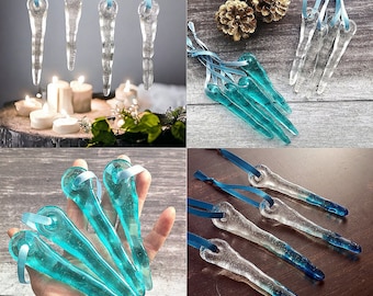 May include: A set of 10 glass icicle ornaments with a blue and clear glass design. The icicles are hanging from a string and are arranged in a variety of positions.