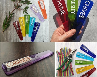 May include: Assortment of colourful glass plant markers with white lettering. The markers are labelled with the names of herbs, including Chives, Parsley, Thyme, Basil, Mint, and Coriander.