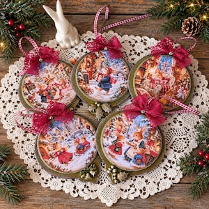 May include: Five round Christmas ornaments featuring detailed illustrations of rabbits in winter scenes. Each ornament is decorated with a dark red lace bow, a checkered ribbon hanger, and small metallic accents at the bottom edge.