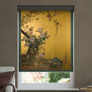 May include: A window roller shade featuring a gold background with a detailed illustration of a flowering tree, pink and white peonies, and a small bird perched near a rock. The design is framed by dark green vertical borders on both sides.