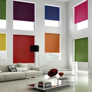 May include: A living room with a white sofa and a glass coffee table. The room has large windows with colourful roller blinds in shades of green, yellow, red, orange, purple, and blue.