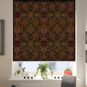 May include: A window blind with a dark brown background and a repeating pattern of gold and red floral designs.