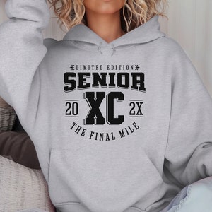 May include: Gray hooded sweatshirt with black text that reads "Limited Edition Senior XC 20 The Final Mile 2X".