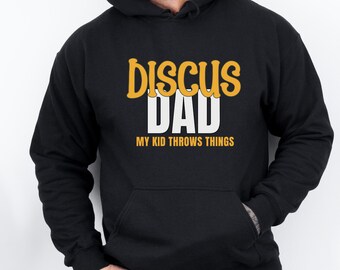 May include: Black hooded sweatshirt with the text "Discuss Dad My Kid Throws Things" in yellow and white lettering.