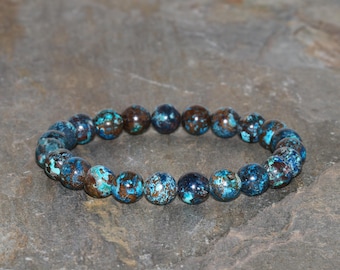 May include: A blue and brown gemstone bracelet with round beads.