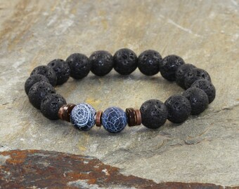 May include: A black lava rock bracelet with two blue agate beads and copper spacers.