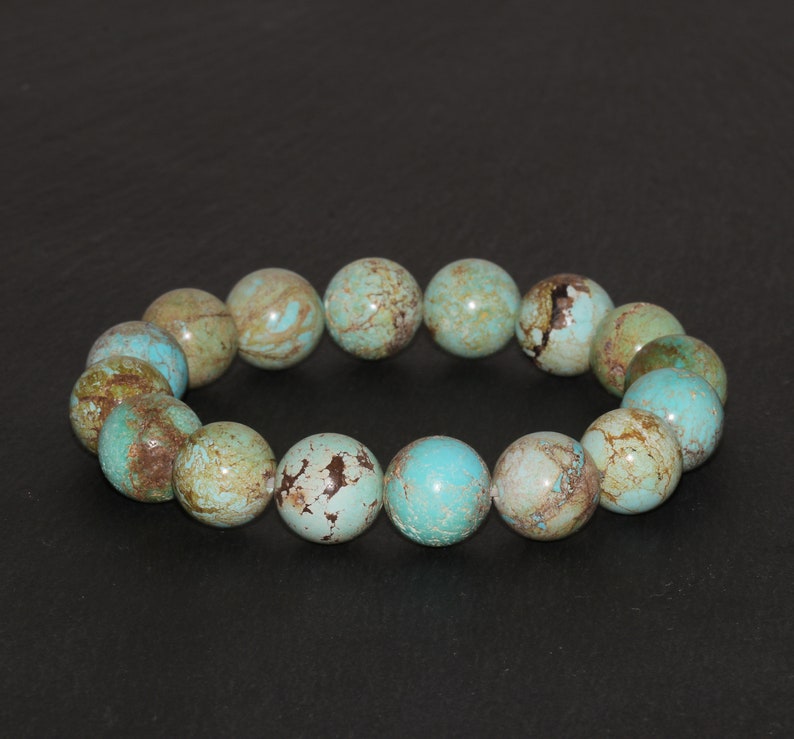 May include: A turquoise and brown beaded bracelet with round beads. The beads have a mottled pattern.