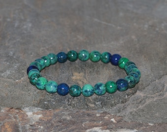 May include: A green and blue gemstone bracelet with round beads. The bracelet is made of malachite and lapis lazuli.