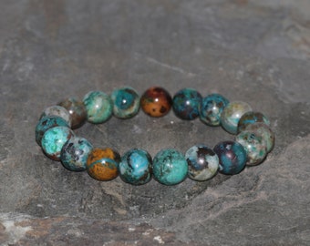 May include: A bracelet made of round, multi-colored turquoise beads. The beads are a mix of blue, green, brown, and white.
