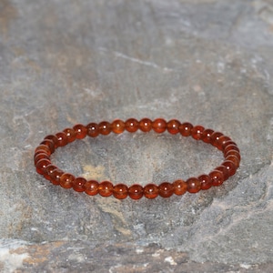 May include: A brown gemstone bracelet with round beads.