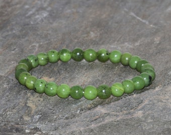 May include: A green jade stone bracelet with round beads.