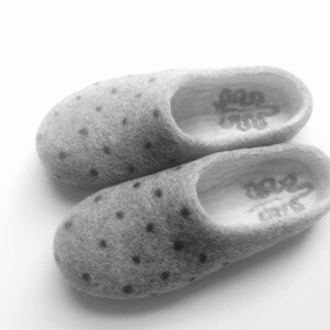 May include: A pair of gray wool slippers with black polka dots. The slippers have a white lining and the text "Love" is embroidered on the inside of each slipper.