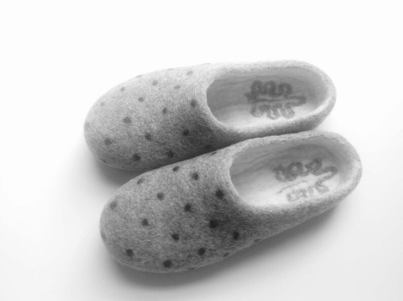 May include: A pair of gray wool slippers with black polka dots. The slippers have a white lining and the text "Love" is embroidered on the inside of each slipper.