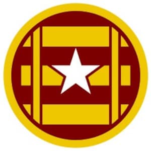 May include: A circular design in red and gold with a white star in the centre. The design resembles a wooden barrel with a star on the front.