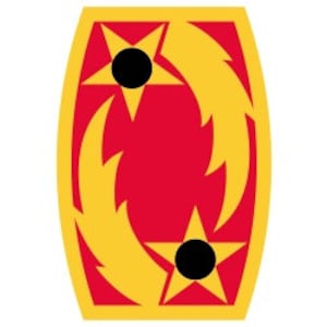 May include: A red and gold military unit patch with two black stars and yellow flames.