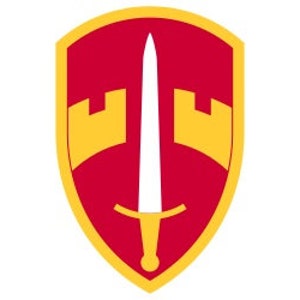 May include: A red shield with a gold border and a white sword in the center. Two gold towers are on either side of the sword.