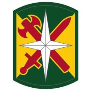 May include: A green, yellow and white military unit patch with a white star in the centre and two crossed swords with red handles.