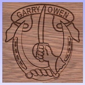 May include: A wooden plaque with a carved design of a horseshoe, a sword, and a hand holding the sword. The text "GARRY OWEN" is carved above the design.