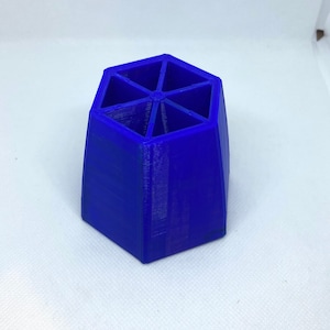 May include: A vibrant blue, hexagonal desk organizer. The organizer is divided into six compartments, perfect for storing pens, pencils, or other small office supplies. The item is made of a solid, smooth material.