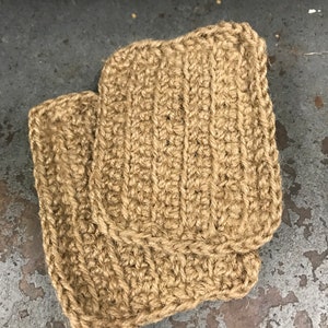 May include: Two brown crocheted pot holders made from natural jute fiber.