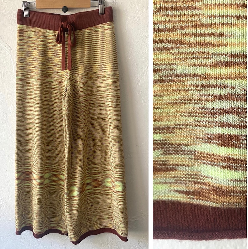 May include: Wide-leg knit pants in a brown, yellow, and green striped pattern. The pants have a drawstring waist and a brown knit waistband.