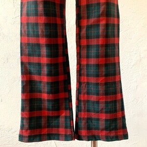 May include: A pair of red and green plaid pants with a wide leg.