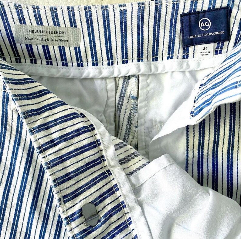 May include: White and blue striped shorts with a white waistband and a label that reads "THE JULIETTE SHORT Nautical High-Rise Short (AG) ADRIANO GOLDSCHMIED 24 MADE IN CHINA"