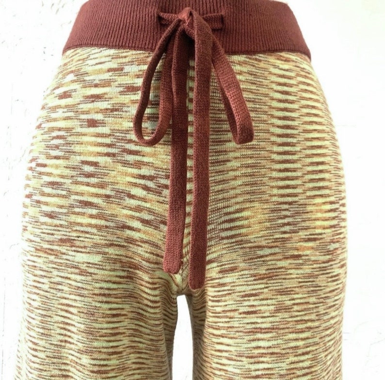May include: Brown and beige knit pants with a brown drawstring waist.